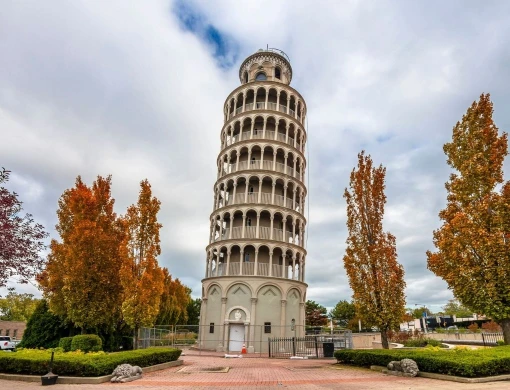 The iconic Leaning Tower of Niles landmark surrounded by autumn trees, representing Elevate Plumbing's dedicated residential and commercial service area in Niles, Illinois.
