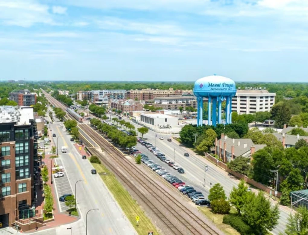 Aerial view of Mount Prospect showing the local water tower, train tracks, and surrounding neighborhoods.