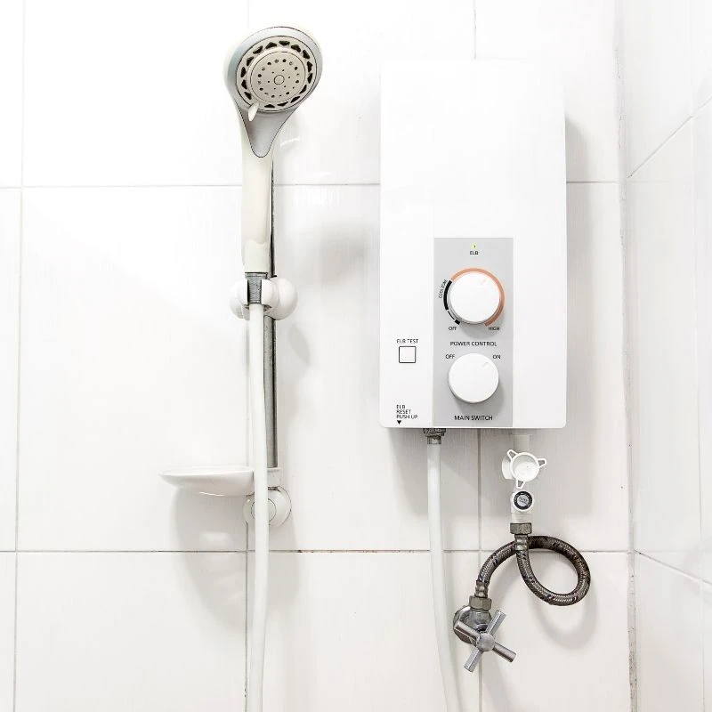 Compact electric point-of-use tankless water heater installed directly in a bathroom shower for instant, reliable hot water in a Park Ridge property.
