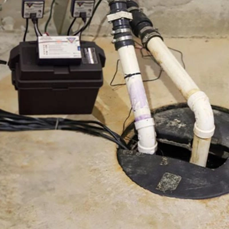 Complete dual sump pump system featuring a dedicated secondary battery backup installation and dual PVC discharge lines for maximum flood security in Skokie.