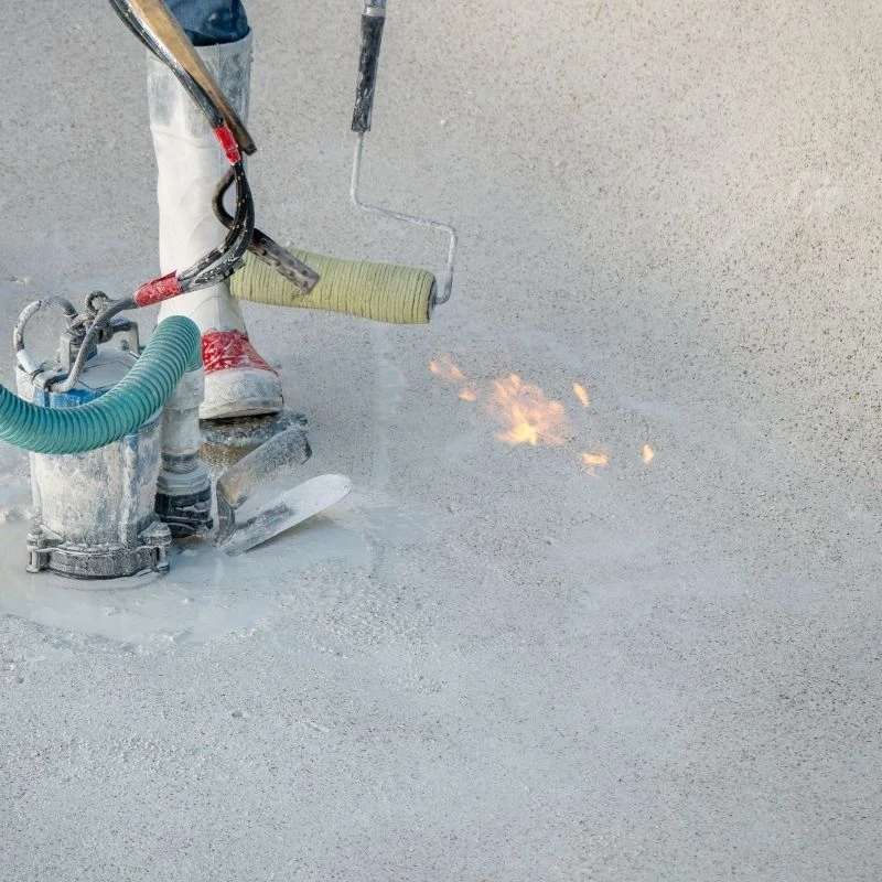 Contractor applying a waterproof concrete finish around an active submersible pump to guarantee maximum basement flood protection for a Skokie homeowner.