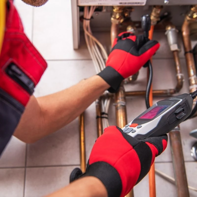 Emergency plumber using advanced electronic leak detection equipment to locate a hidden copper pipe leak for a Northwest Chicago homeowner.